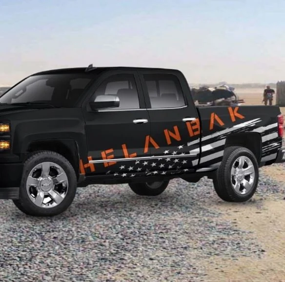 Black Helanbak pickup with orange lettering and side graphics